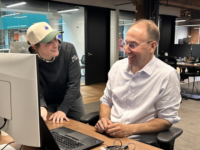 OTTO SPORT AI teammates sharing a laugh at the office